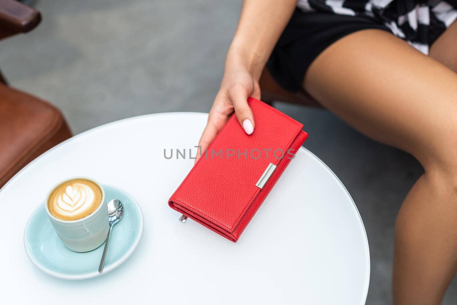 Wallet on the table and a cup of coffee