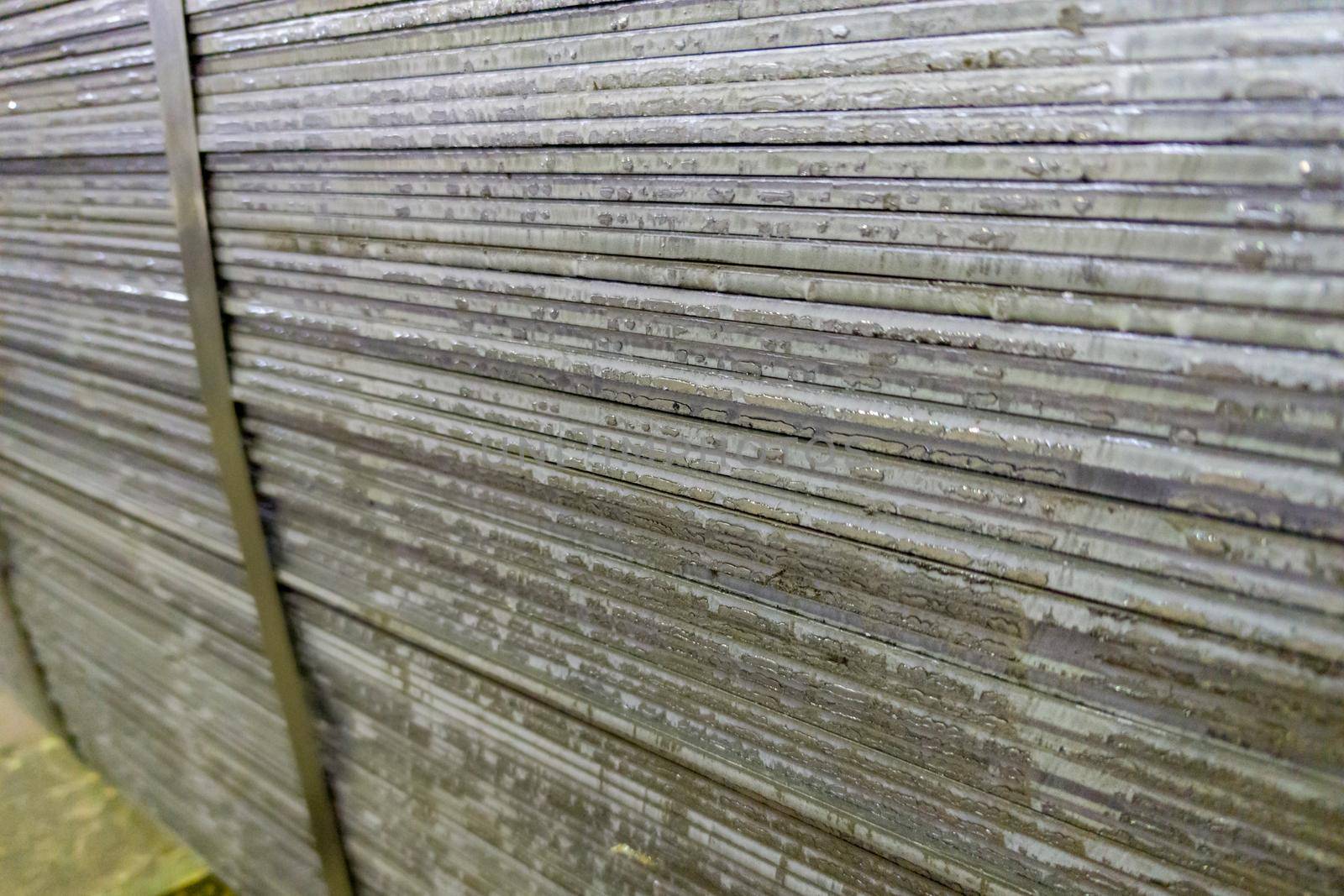 stack of mild steel sheets, full-frame close-up view with selective focus, industrial material background