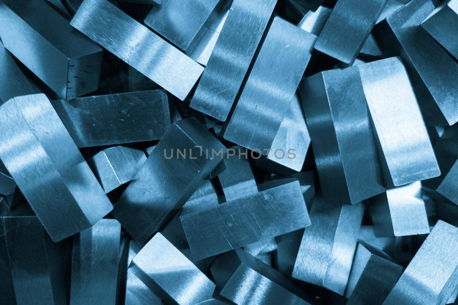 pile of rectangular steel workpieces after surface grinding, full-frame closeup background