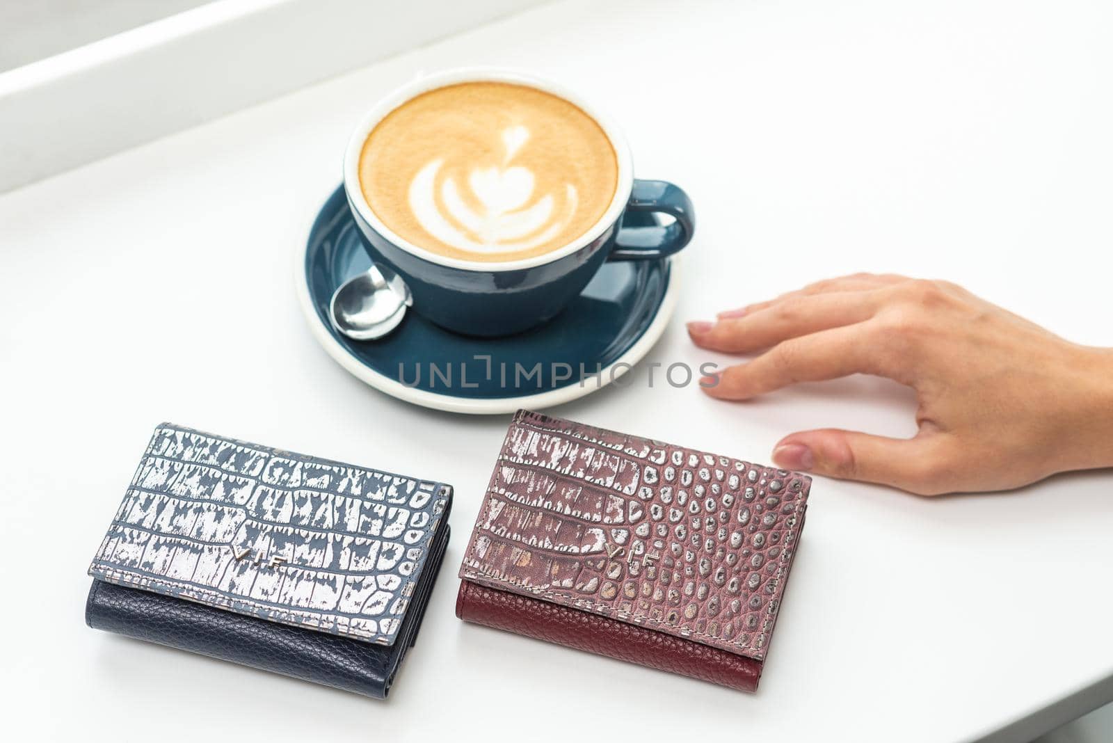 two purses with a cup of coffee on a white table by wip3out