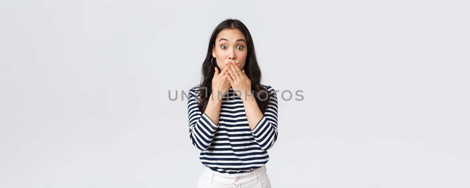 Lifestyle, beauty and fashion, people emotions concept. Shocked speechless asian girl found out someone secret, gasping and cover mouth, express surprise with widened eyes by Benzoix