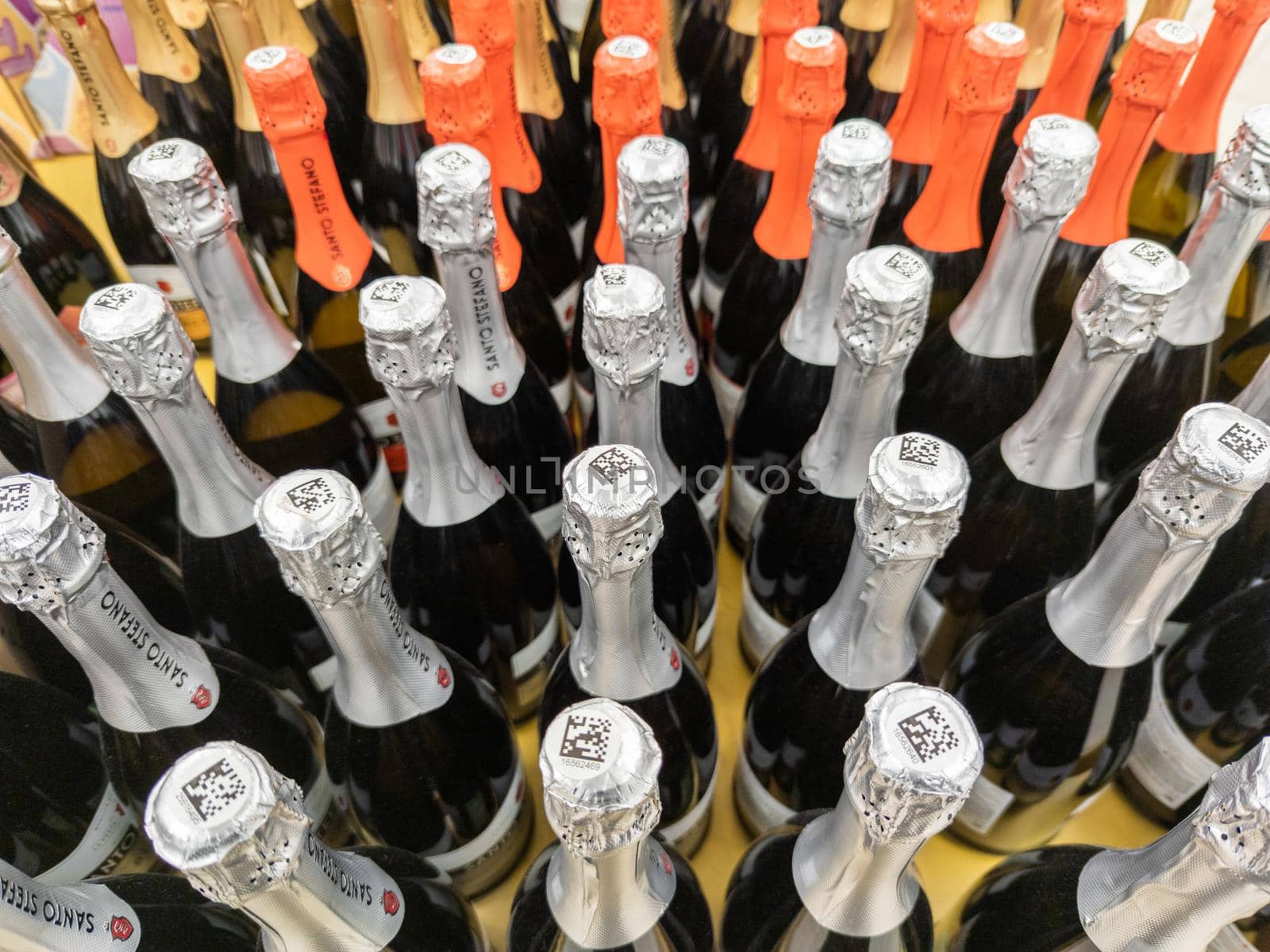 many bottles of champagne in a grocery store closeup with selective focus and wide angle in Tula, Russia - March 3, 2022