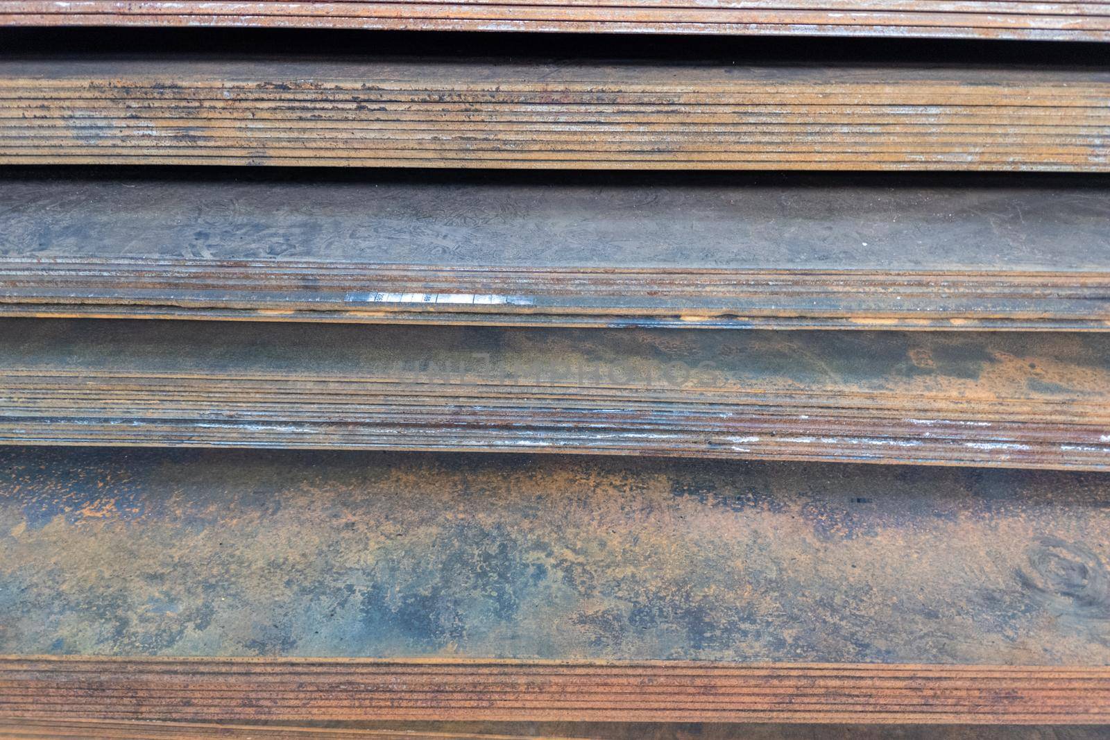 stack of mild steel sheets, full-frame close-up view with selective focus, industrial material background
