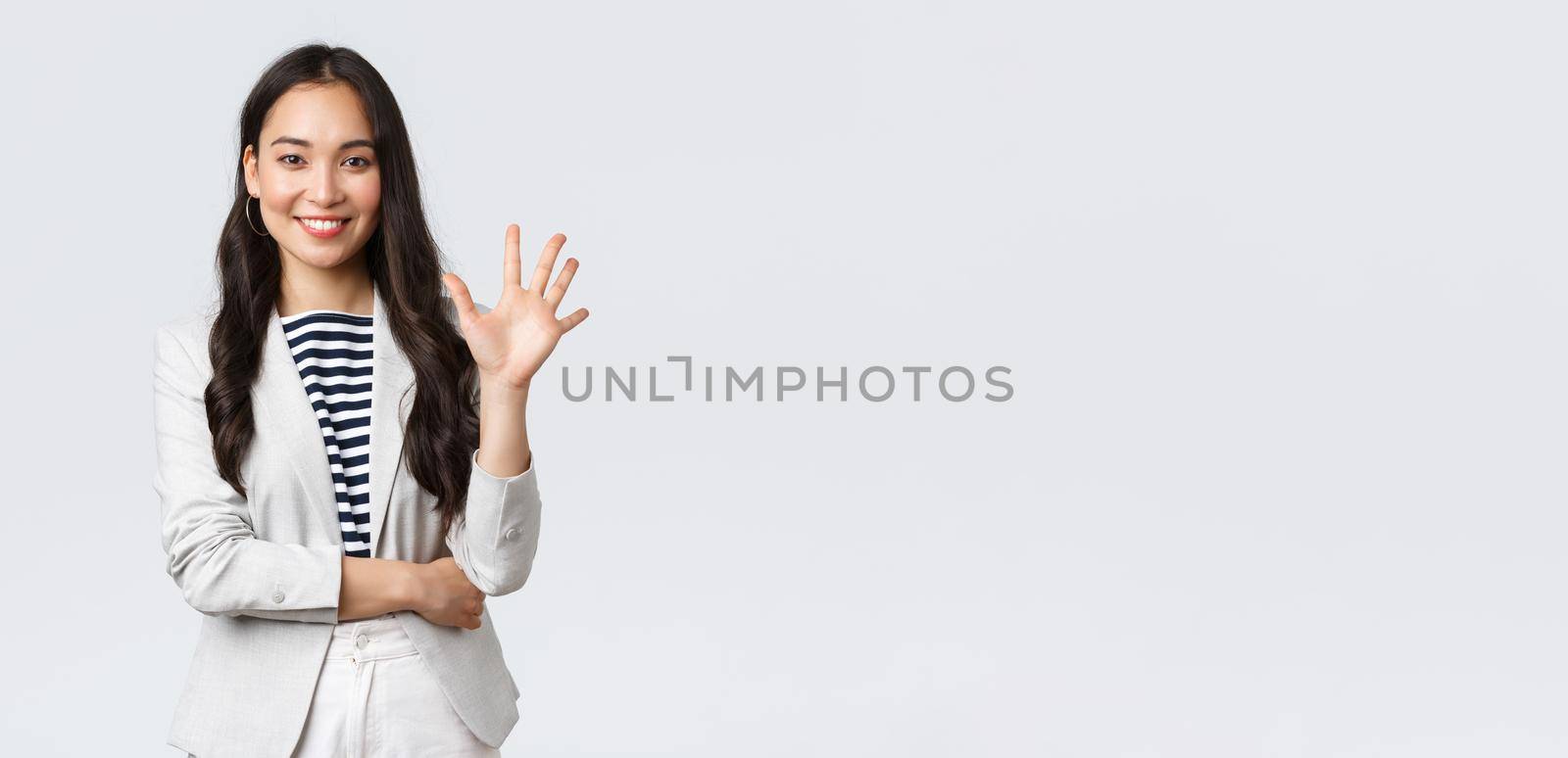 Business, finance and employment, female successful entrepreneurs concept. Successful female businesswoman, asian real estate broker pointing finger, showing number five and smiling by Benzoix