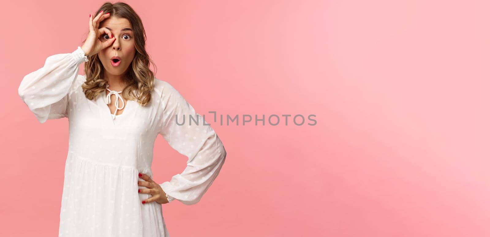 Portrait of amazed and intrigued young blond girl seeing something awesome, look from okay sign with startled excited expression, fold lips say wow, pop eyes at camera, pink background by Benzoix