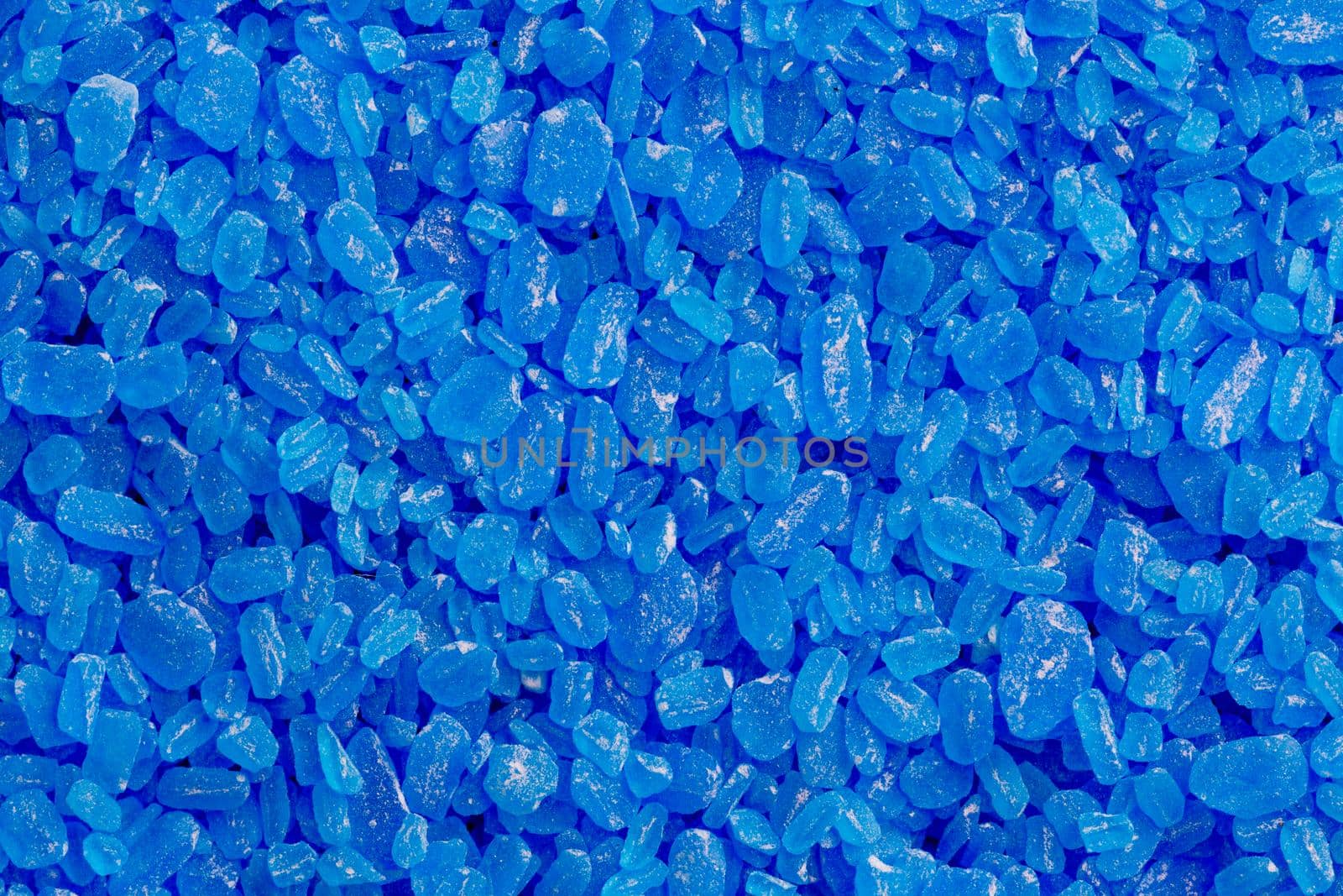 full frame background and texture of blue copper sulfate granules - close-up.