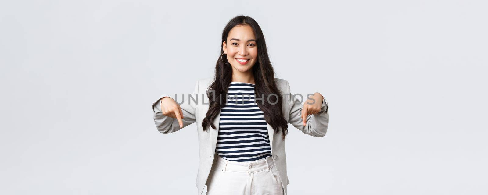 Business, finance and employment, female successful entrepreneurs concept. Confident professional female asian real estate broker showing good deal, pointing fingers down and smiling.