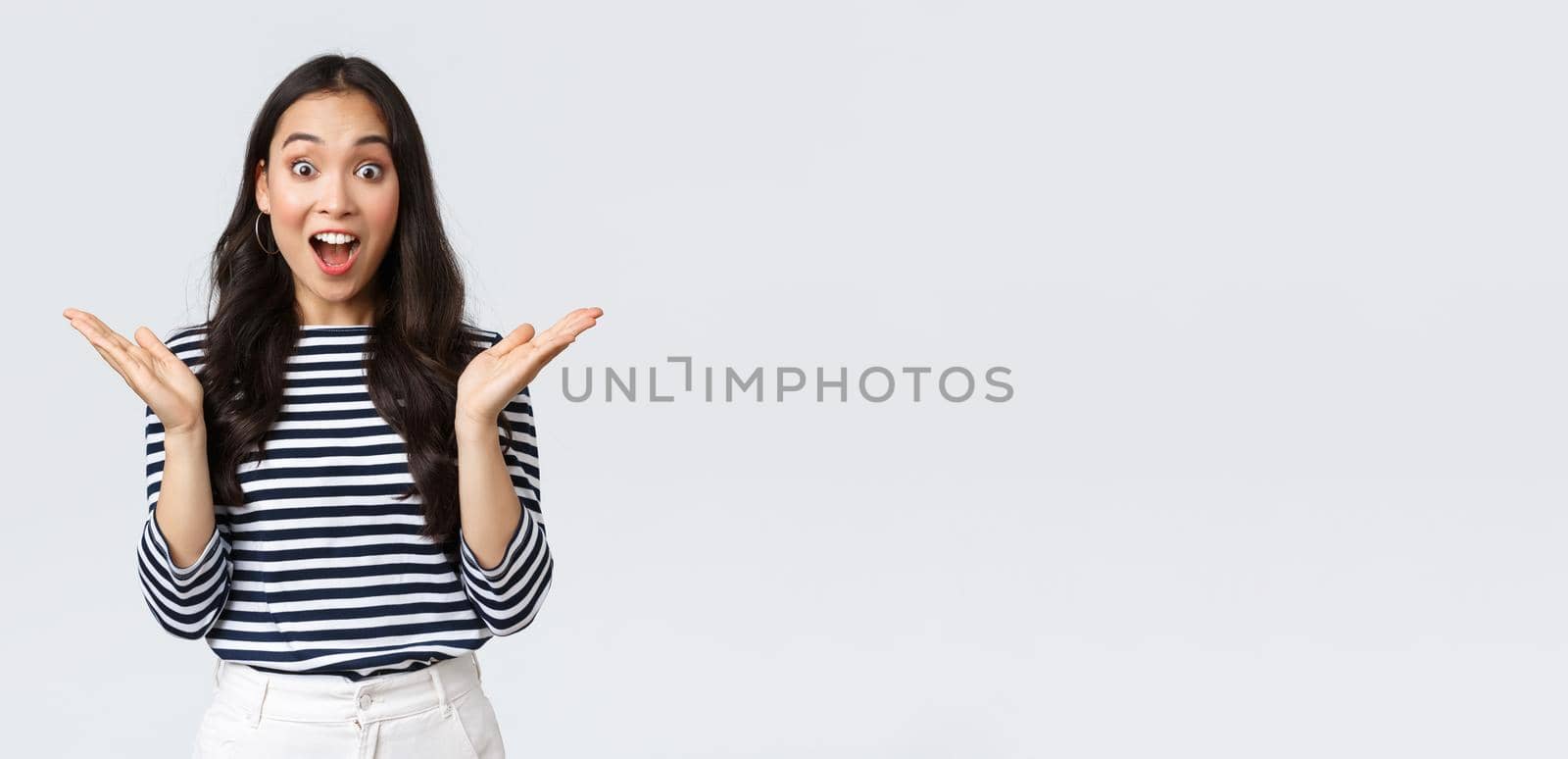 Lifestyle, people emotions and casual concept. Surprised excited asian woman found out awesome big news, clap hands amazed and gasping wondered, standing white background.
