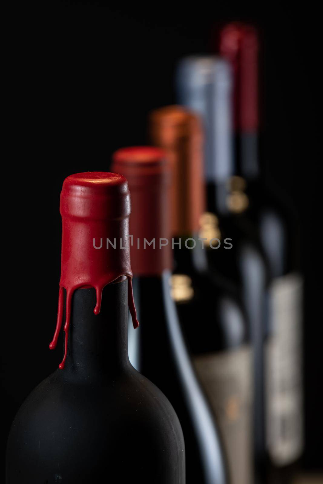 Set of collars red wine bottles isolated on black background, France