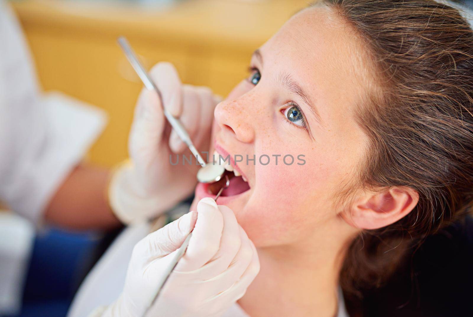 Shot of a female dentist and child in a dentist office.