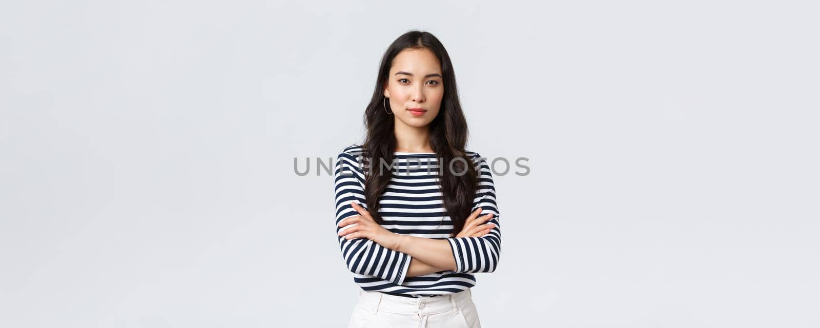 Lifestyle, people emotions and casual concept. Confident nice smiling asian woman cross arms chest confident, ready to help, listening to coworkers, taking part conversation.