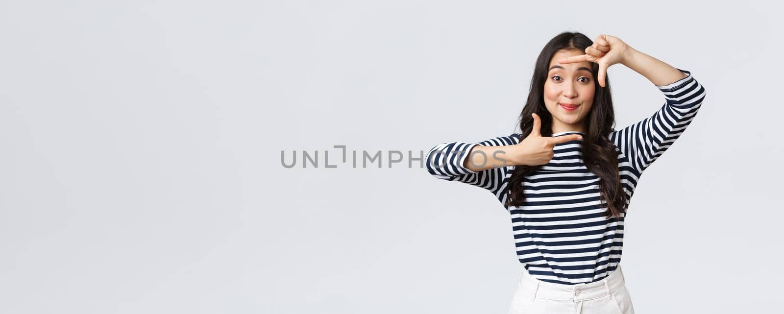 Lifestyle, people emotions and casual concept. Creative cute asian girl picturing, capture moment with hand frames gesture, smiling amused, staying positive and happy, white background by Benzoix