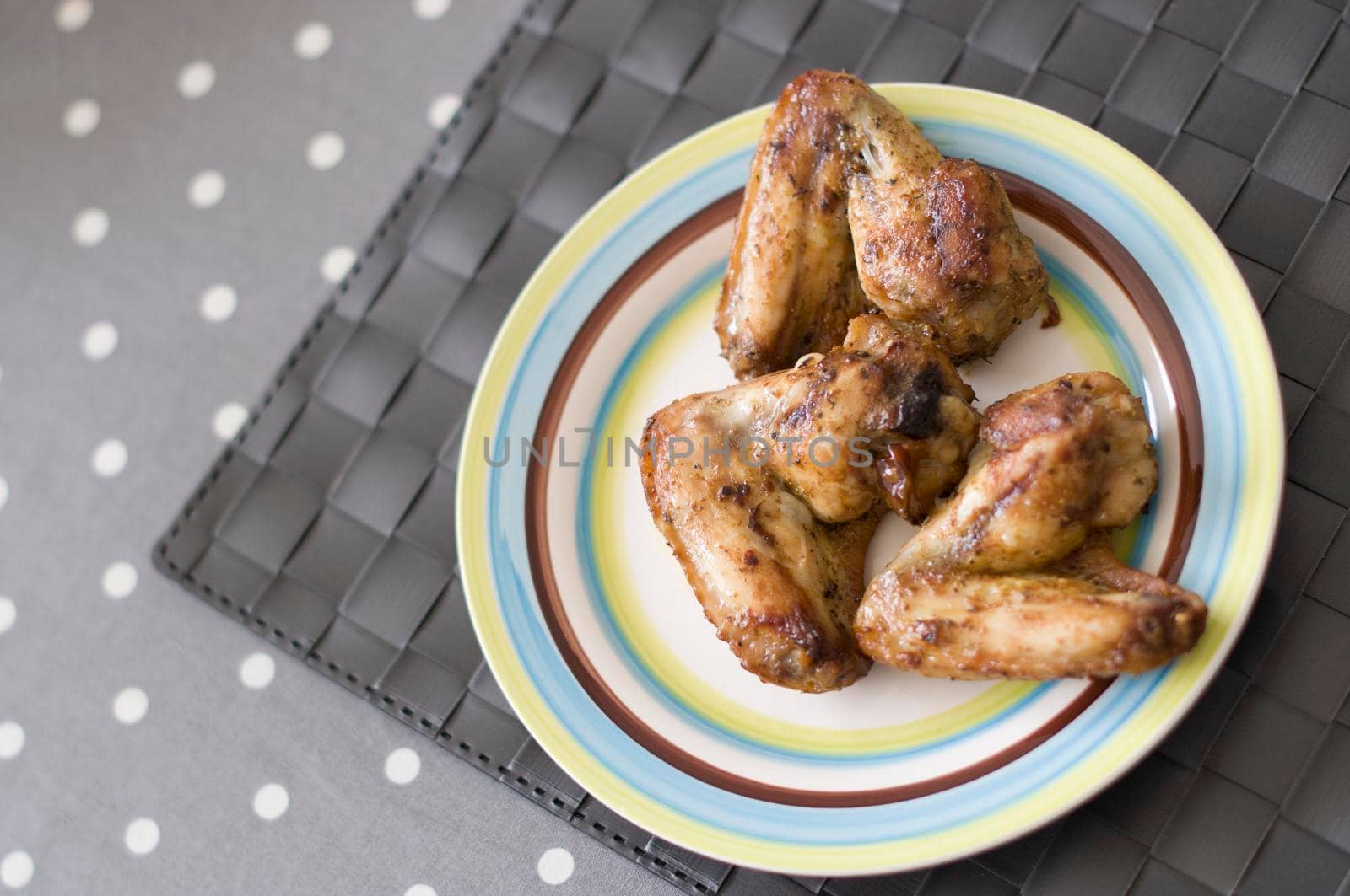 grilled chicken wings close up on the plate on the table, Meat food concept. High quality photo