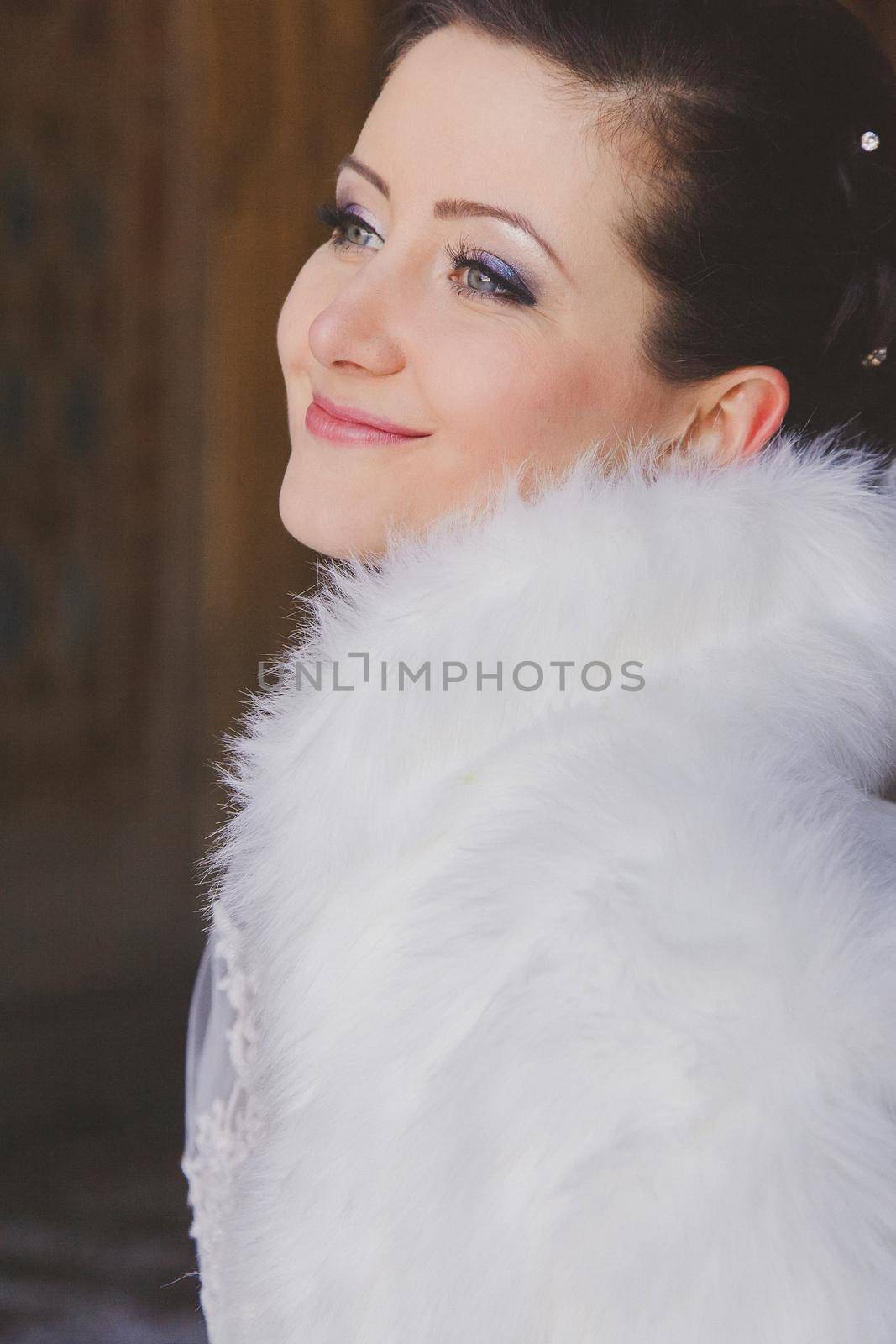 Beautiful bride in a fur cape with by ungvar