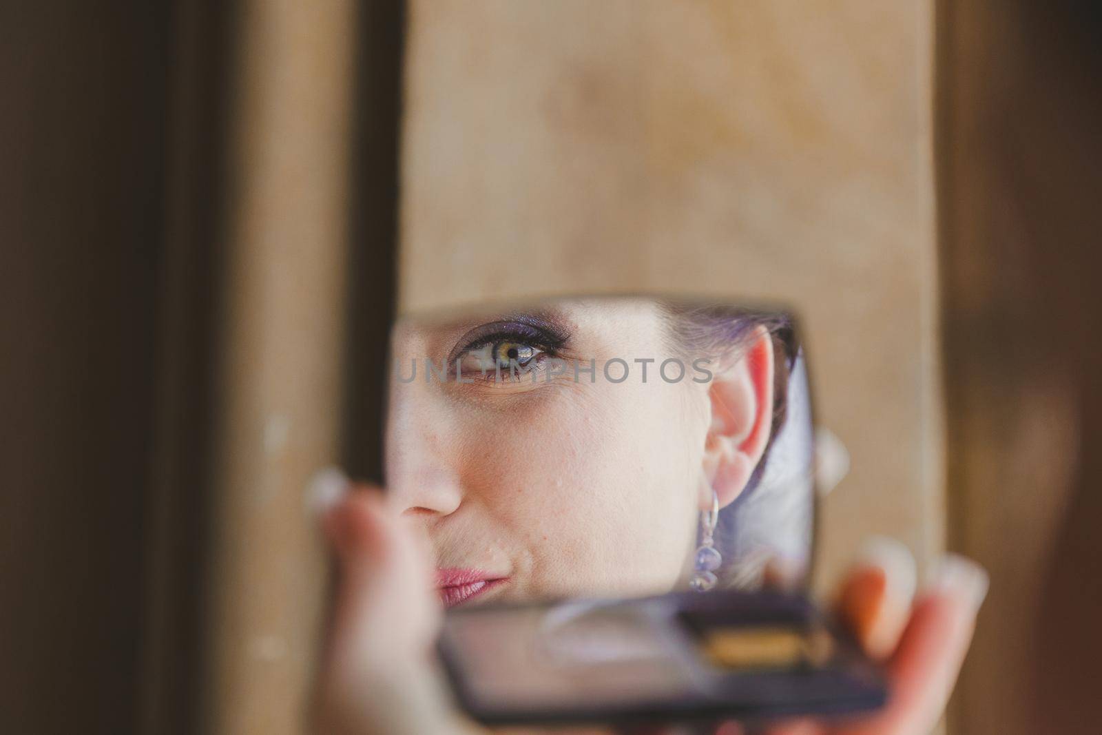 Gorgeous beautiful exotic bride with green eyes mirror reflection face closeup