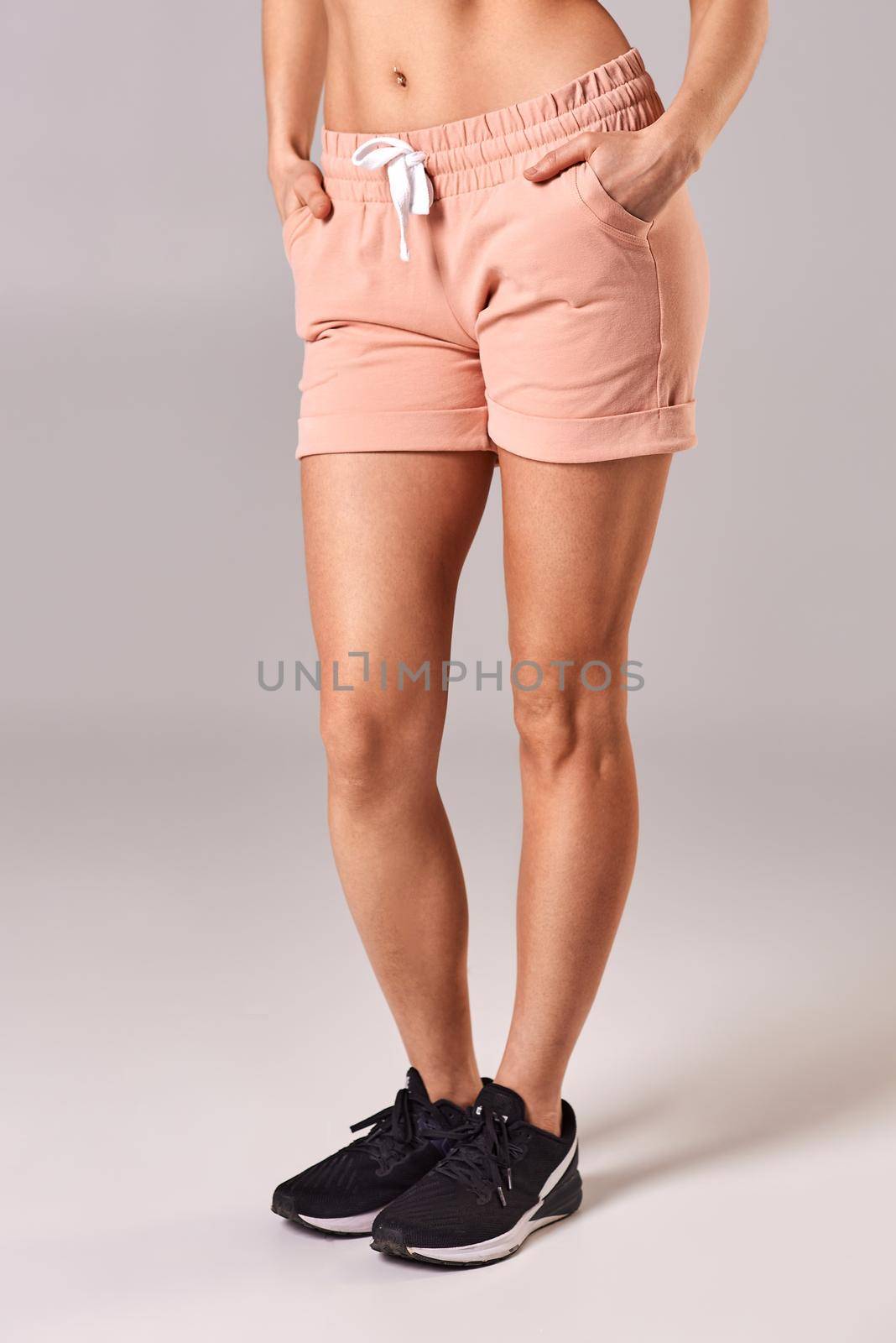 Tanned girl in pink shorts