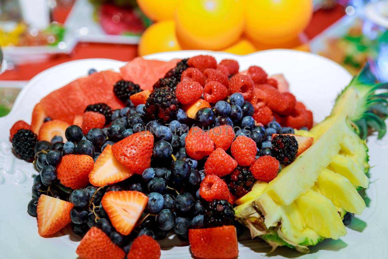 Fruits on a plate salad with fresh fruits and berries