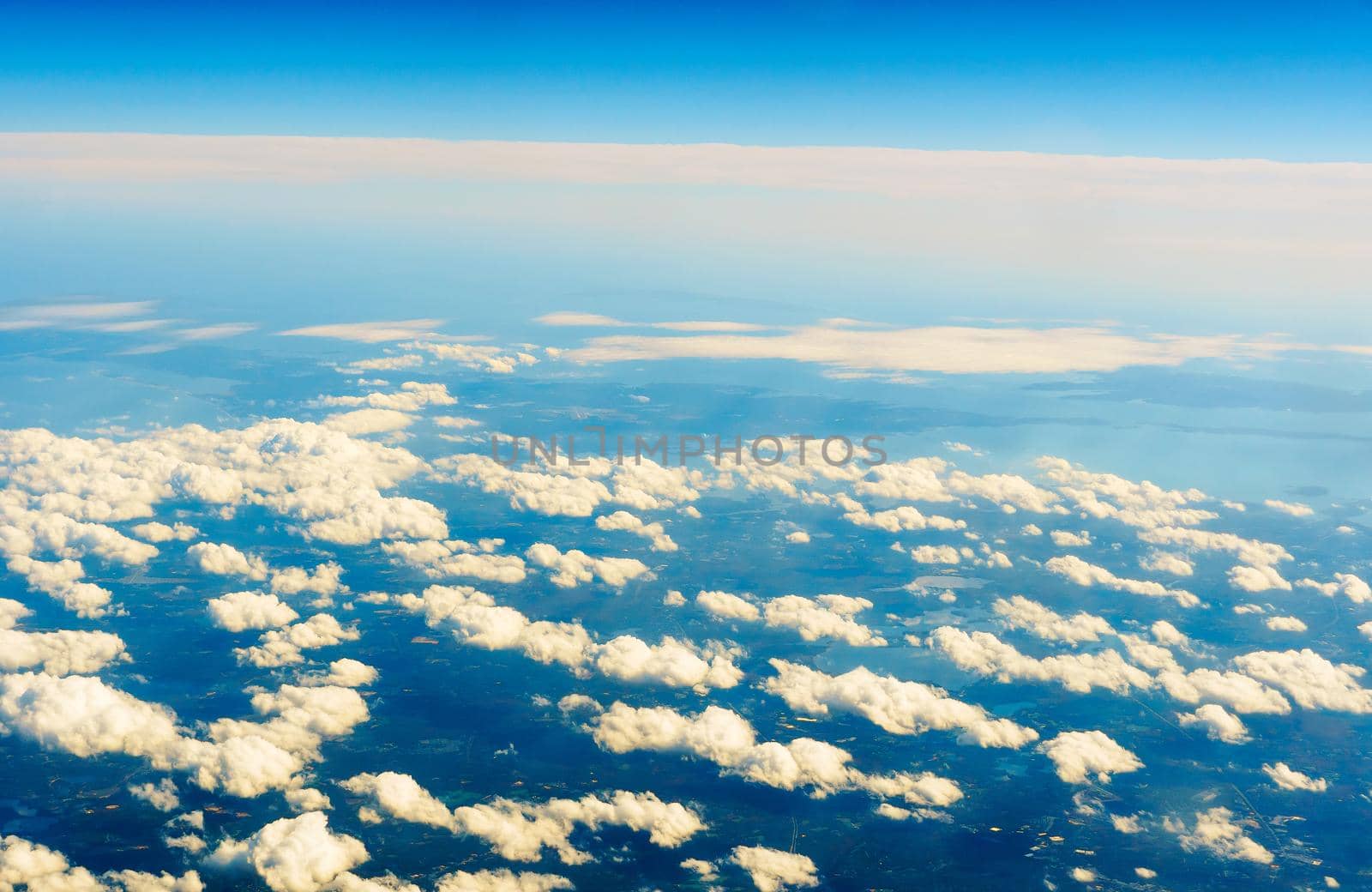 Fluffy white clouds and blue sky seen from airplane. flight cloud sky