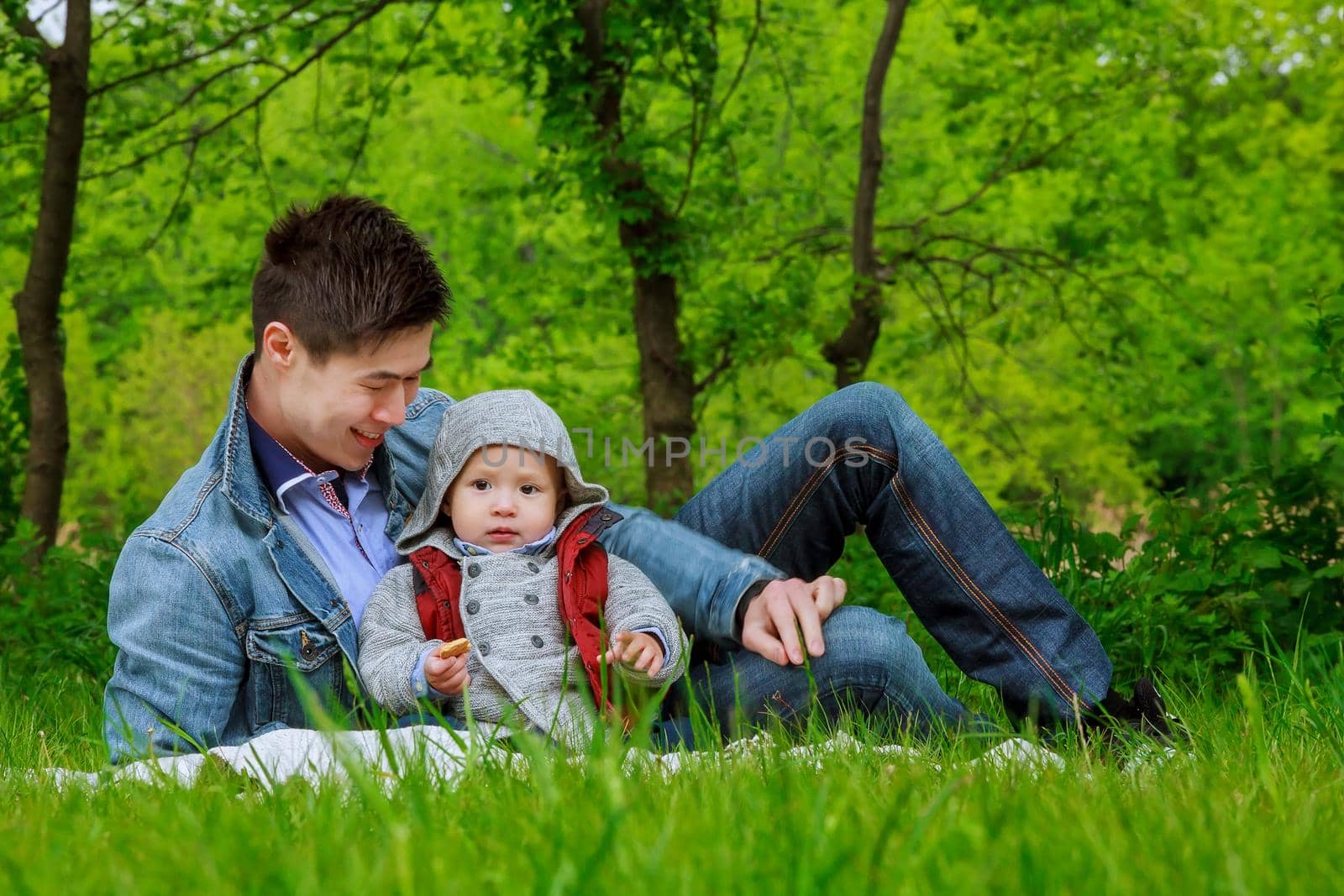 Young dad spending time with his son in the park.