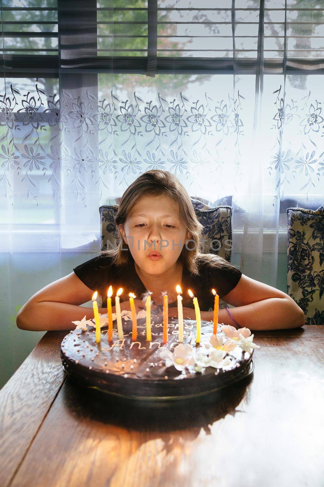 happy little girl indoors with a birthday cake