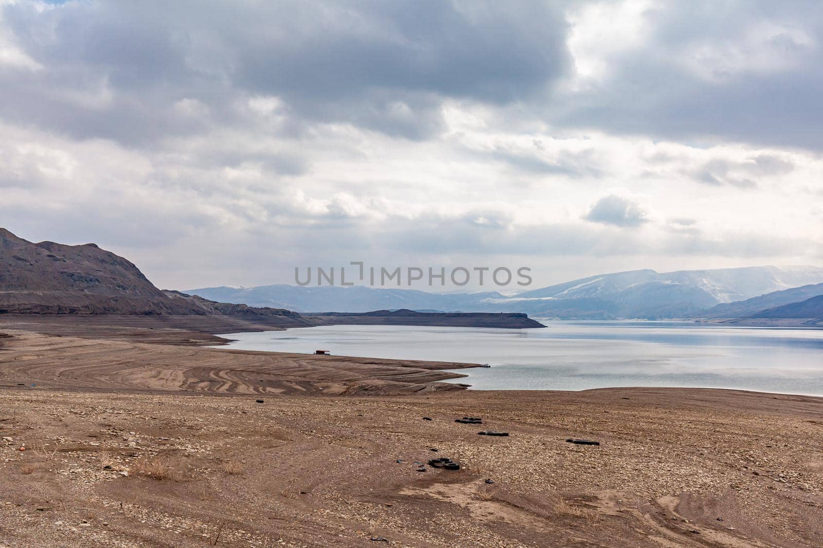 A beautiful reservoir in the mountains. Low water level, drought by AnatoliiFoto