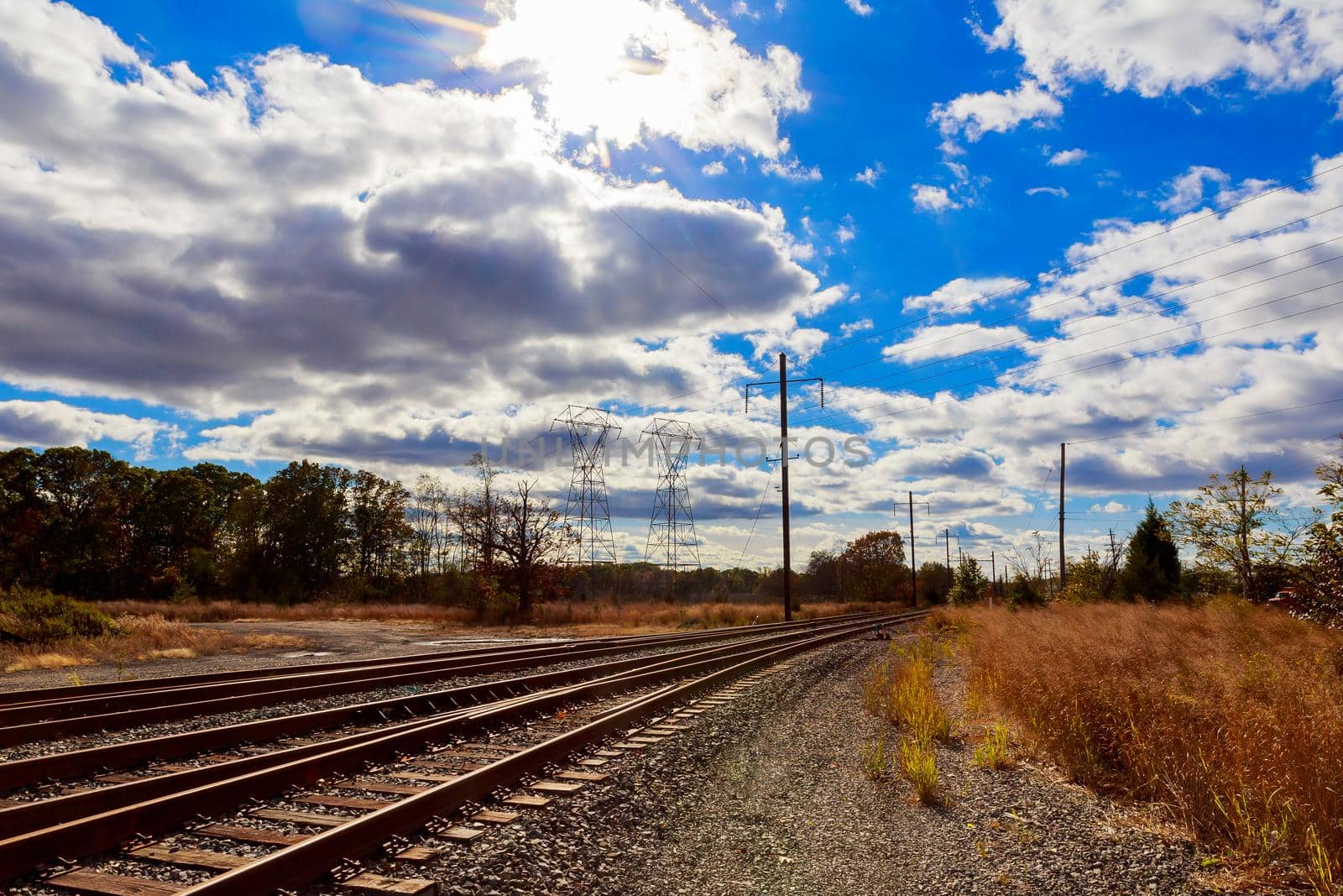 Industrial landscape - old abandoned industrial zone in autumn forest autumn sky clouds power line railroad