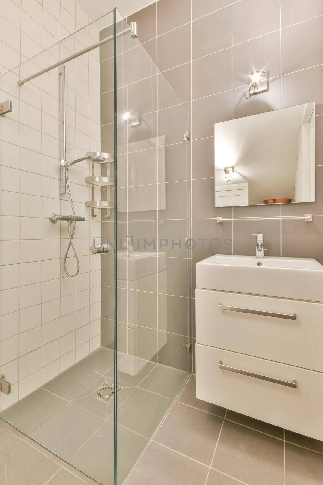 Interior of a shower cabin with a glass wall and a ceramic sink in a modern house