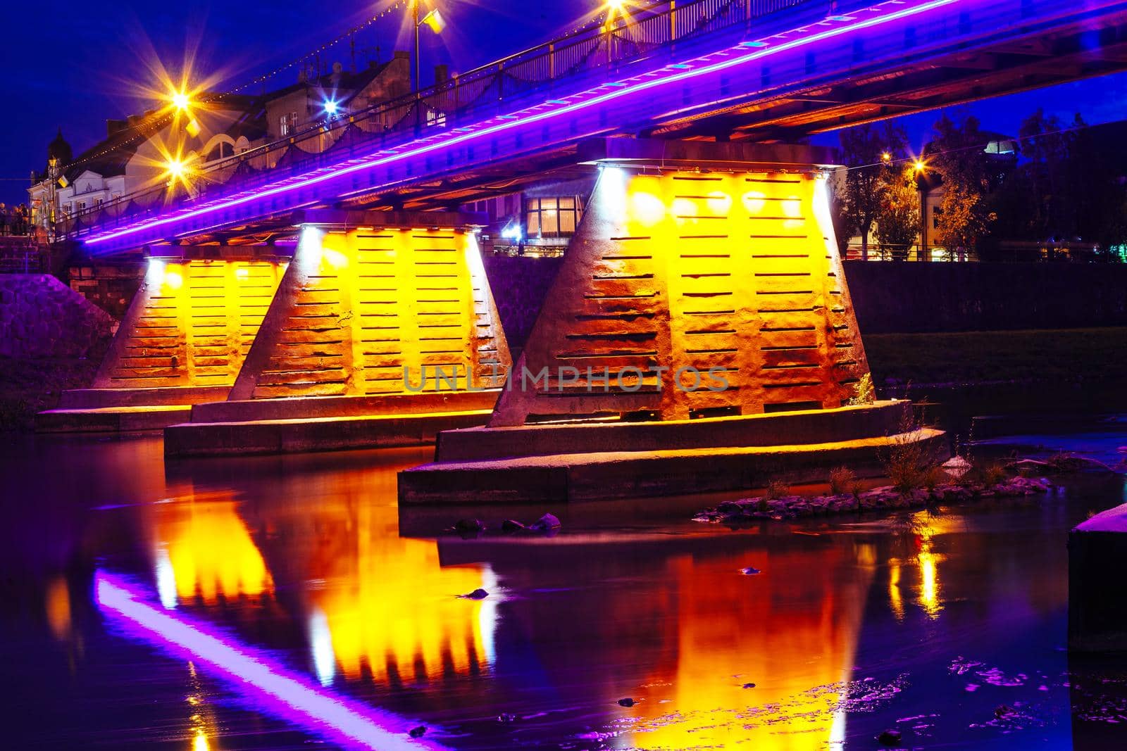 bridge night city reflected in water with lights and reflections. Uzghorod Uzhhorod