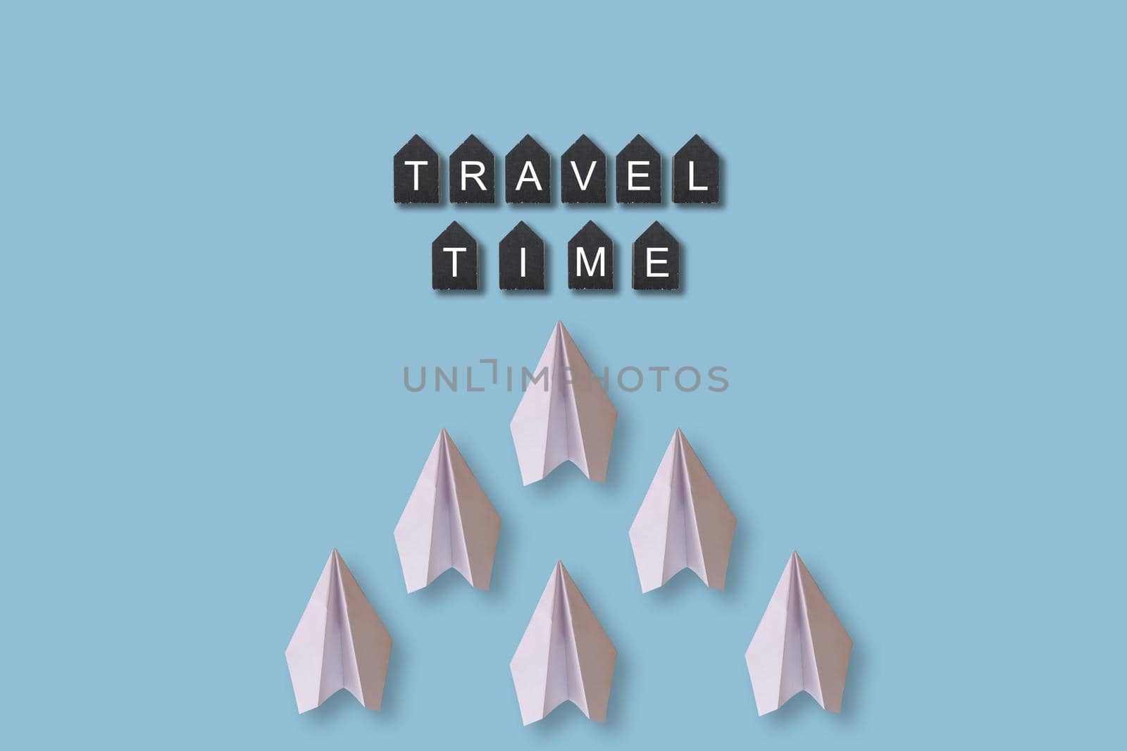 White paper airplanes on color background, travel and holiday concept. by Andelov13