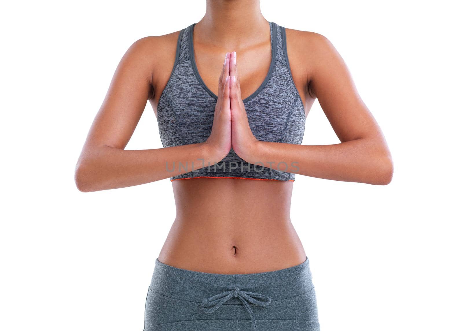 Cropped shot of a female athlete meditating against a white background.
