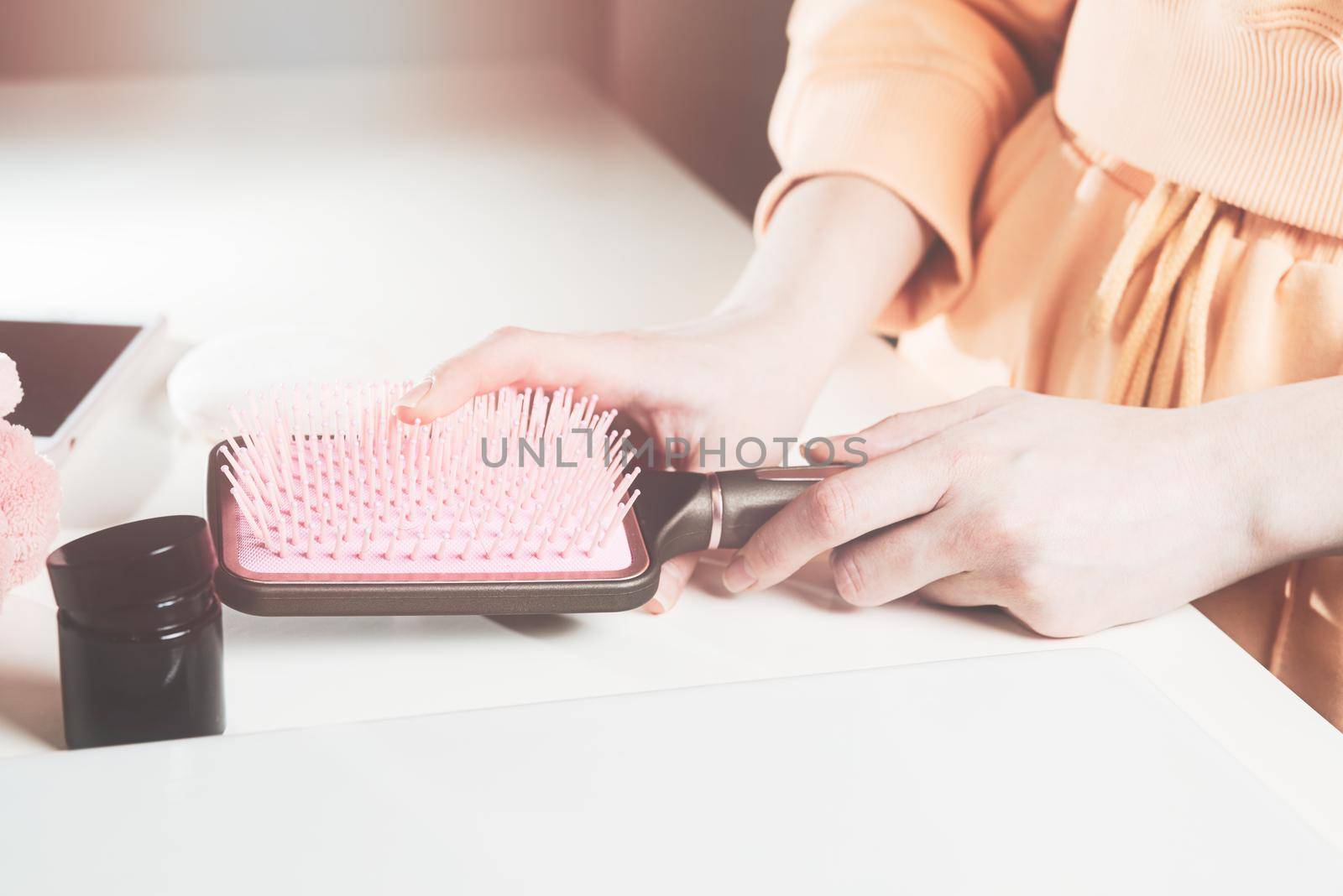 Young womans hands holds hairbrush. soft light by Ashtray25