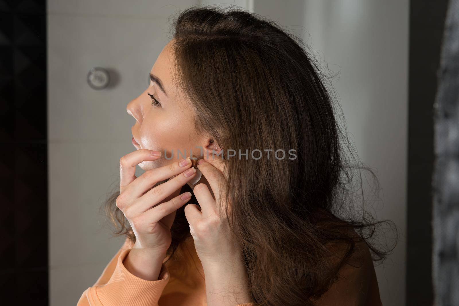 close up of beautiful woman puts on heart shaped earrings by Ashtray25