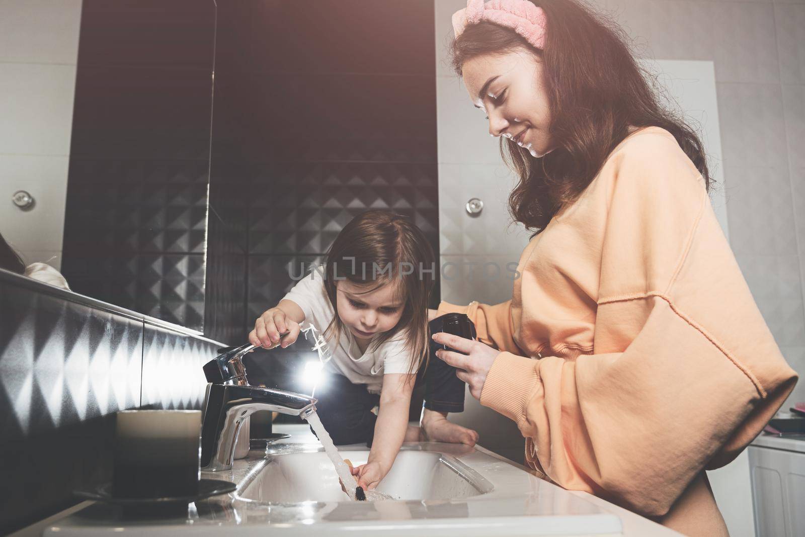 happy family and health. mother and daughter baby girl brushing their teeth together by Ashtray25