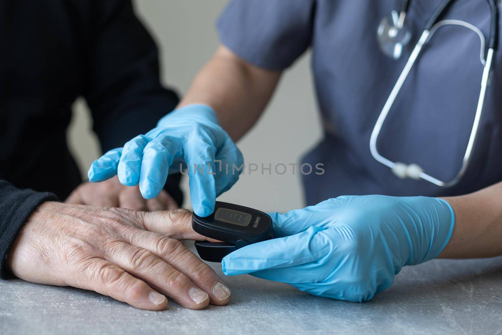 elderly man and nurse measuring pulse oximeter.