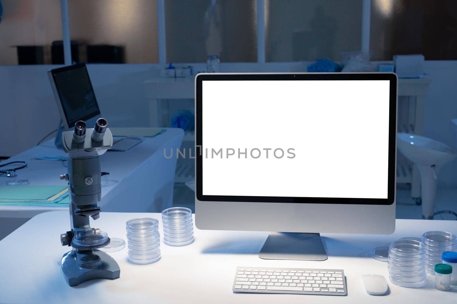 Desktop computer with illuminated screen at workstation in medical laboratory. healthcare and medical research technology.