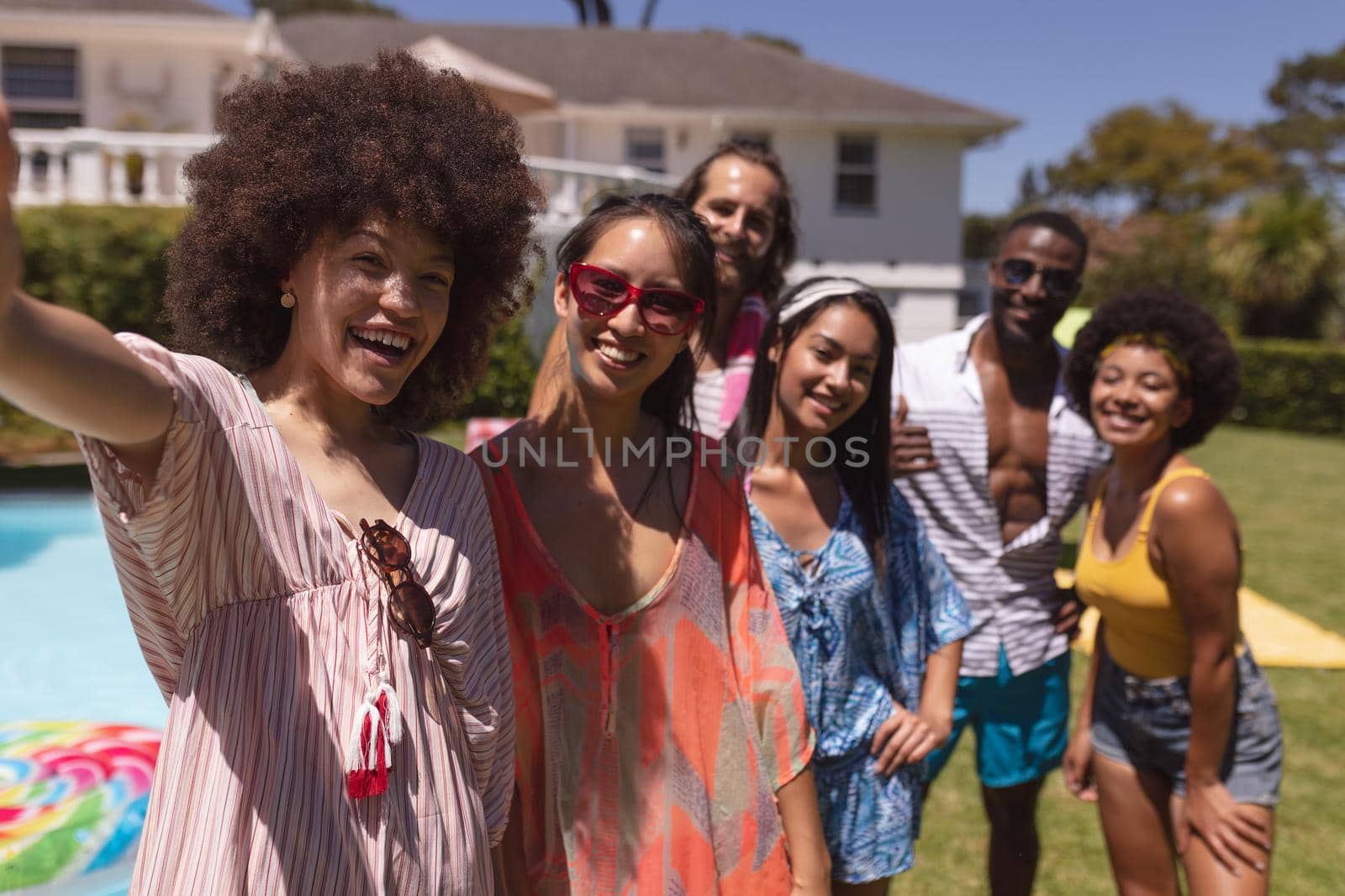 Portrait of diverse group of friends taking selfie at a pool party by Wavebreakmedia