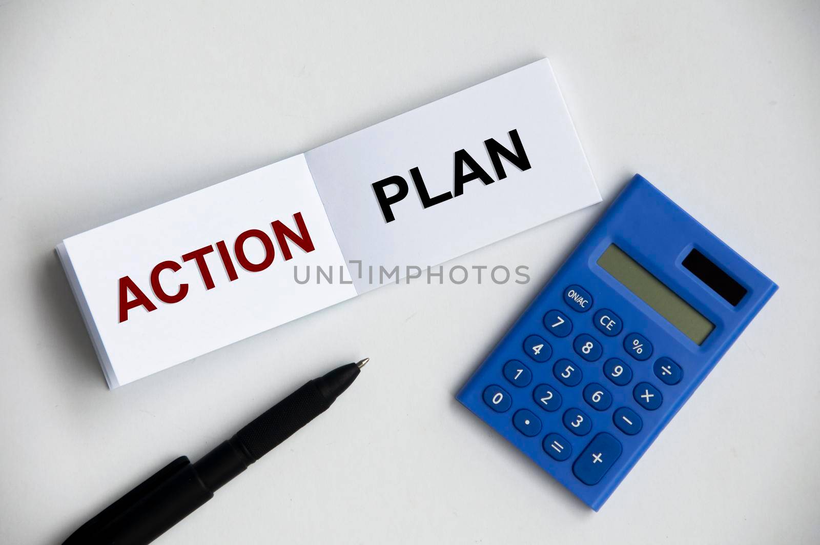 Action plan text on notepad with pen and calculator. Business strategy concept