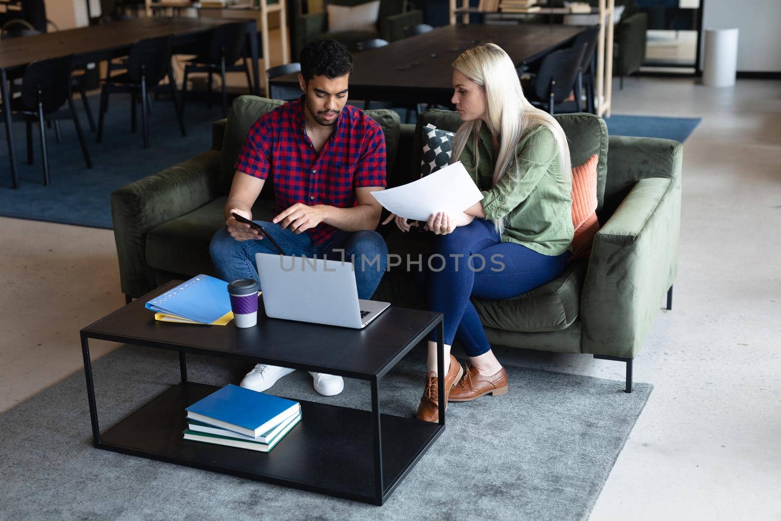 Two diverse business people working in creative office by Wavebreakmedia