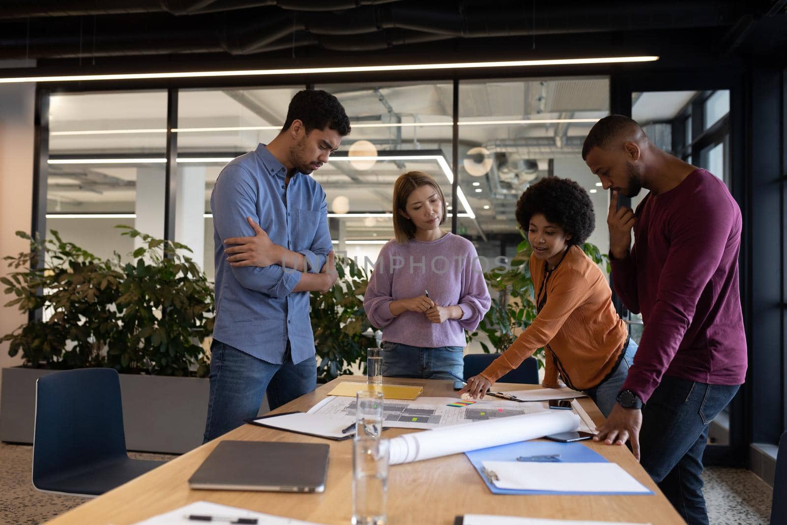 Diverse group of business people working in creative office. group of people in a meeting discussing work. business people and work colleagues at a busy creative office.