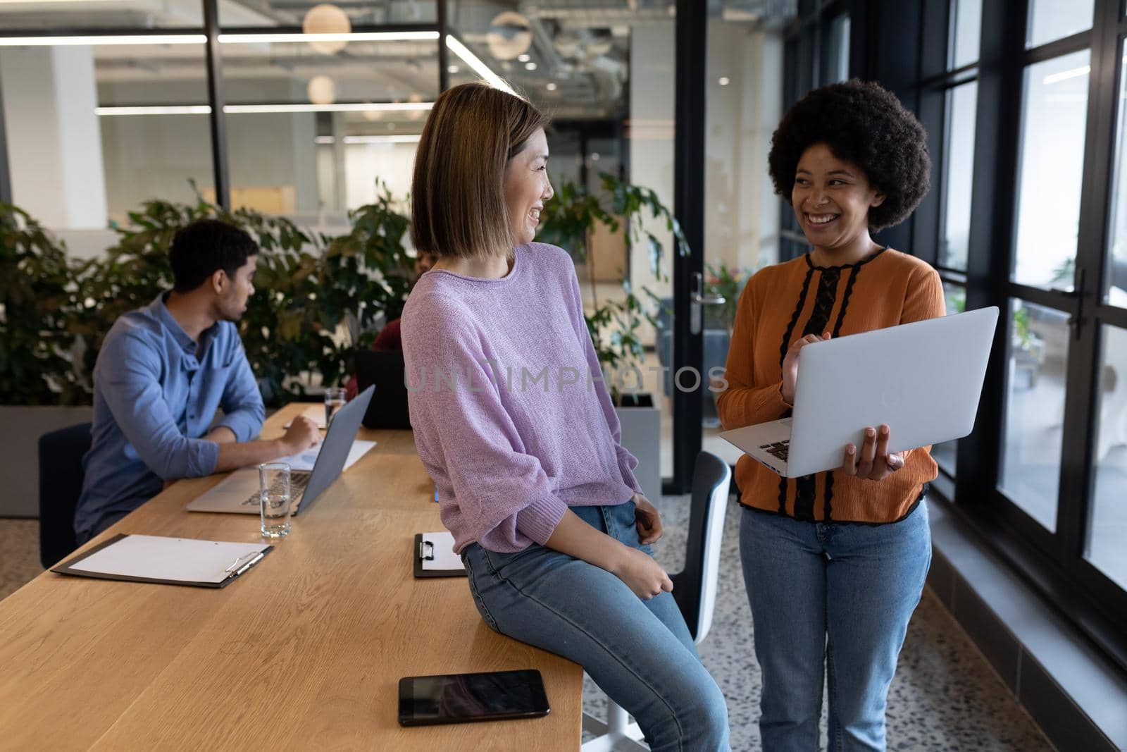 Diverse group of business people working in creative office. group of people in a meeting discussing work. business people and work colleagues at a busy creative office.