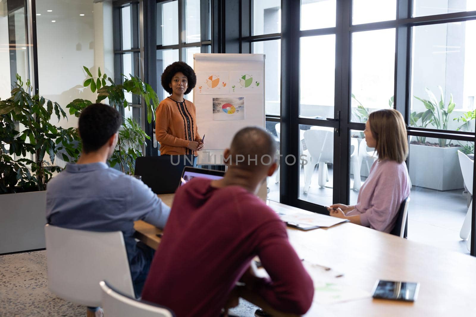 Diverse group of business people working in creative office. group of people in a meeting discussing work. business people and work colleagues at a busy creative office.