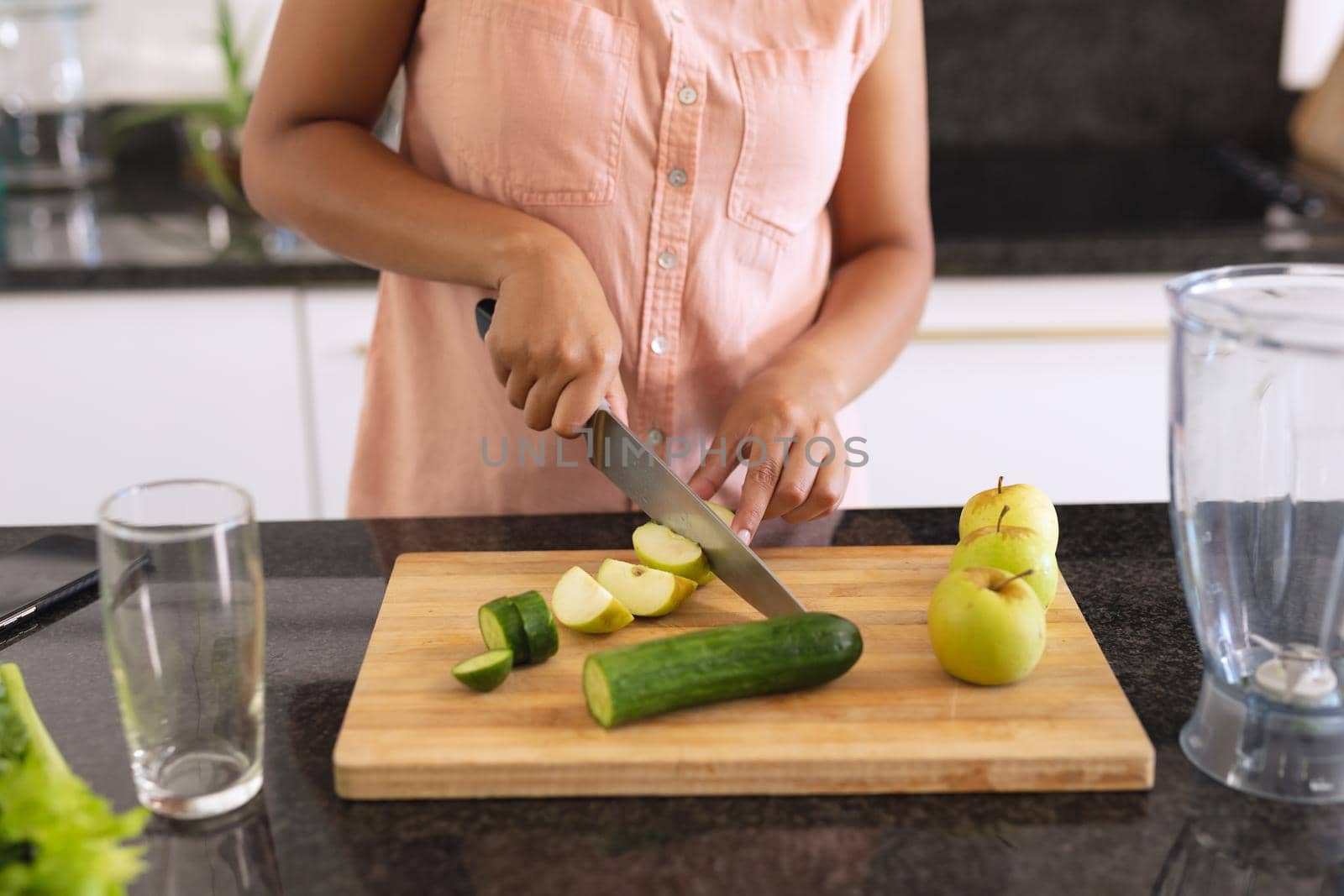 African american woman in kitchen making health drink by Wavebreakmedia