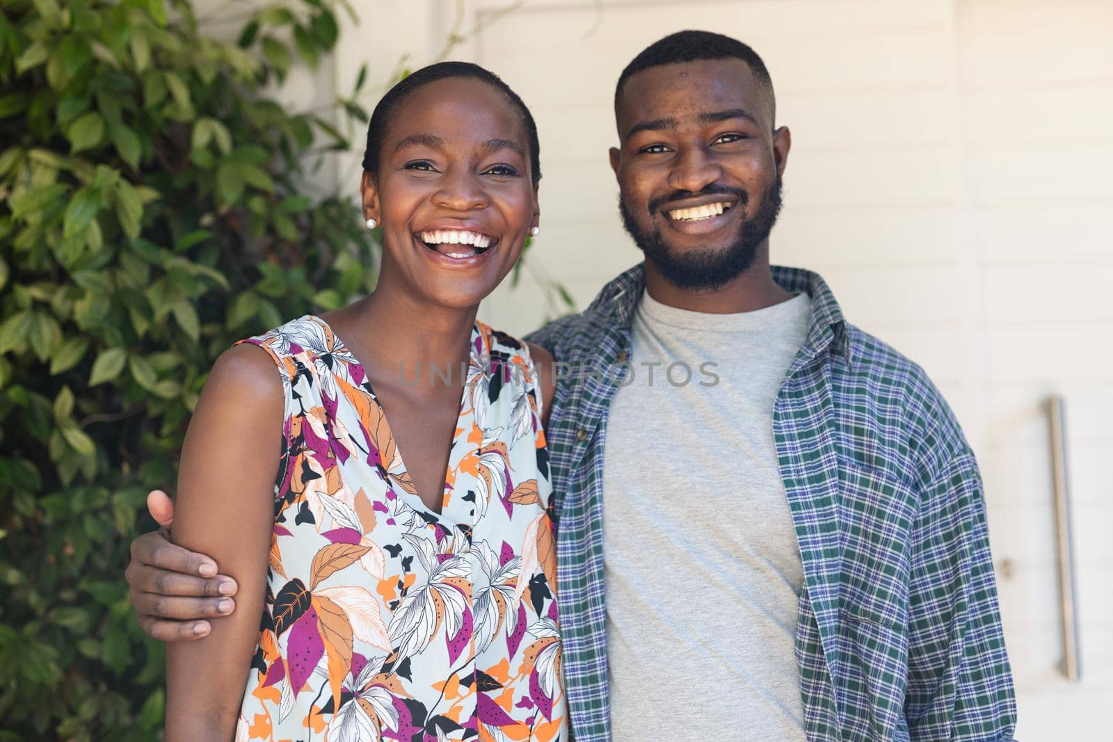 Portrait of smiling african american couple embracing in the garden. staying at home in isolation during quarantine lockdown.