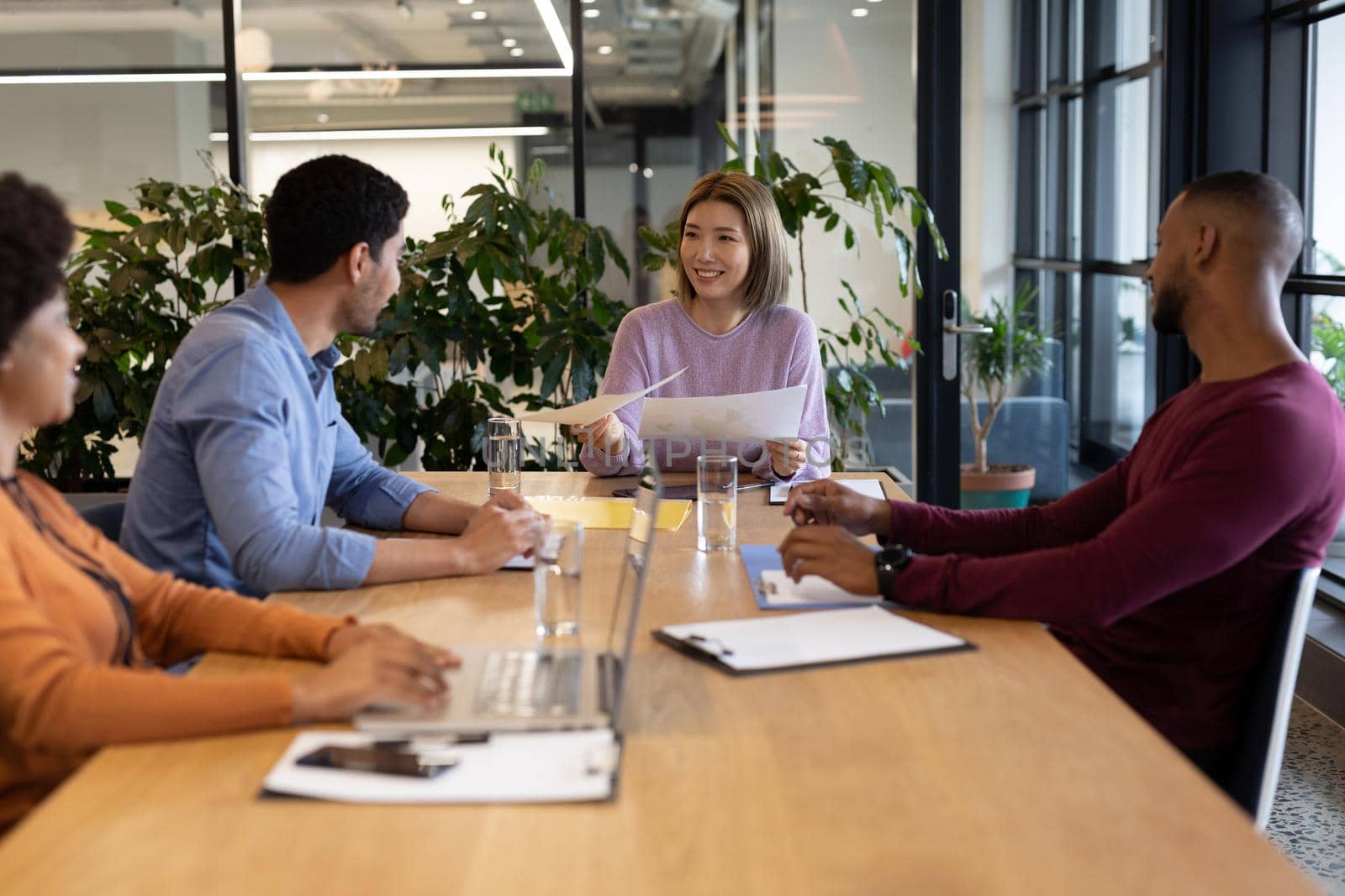 Diverse group of business people working in creative office. group of people in a meeting discussing work. business people and work colleagues at a busy creative office.