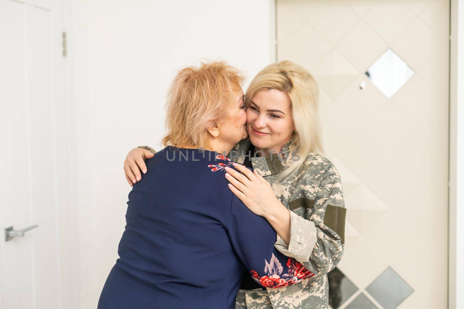 military woman and elderly mother at home.