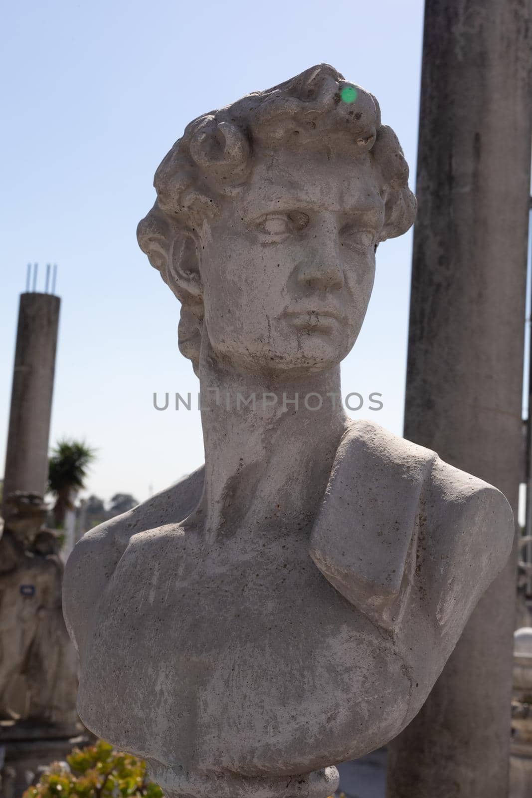 Ancient stone sculpture of man's bust in reclamation yard by Wavebreakmedia