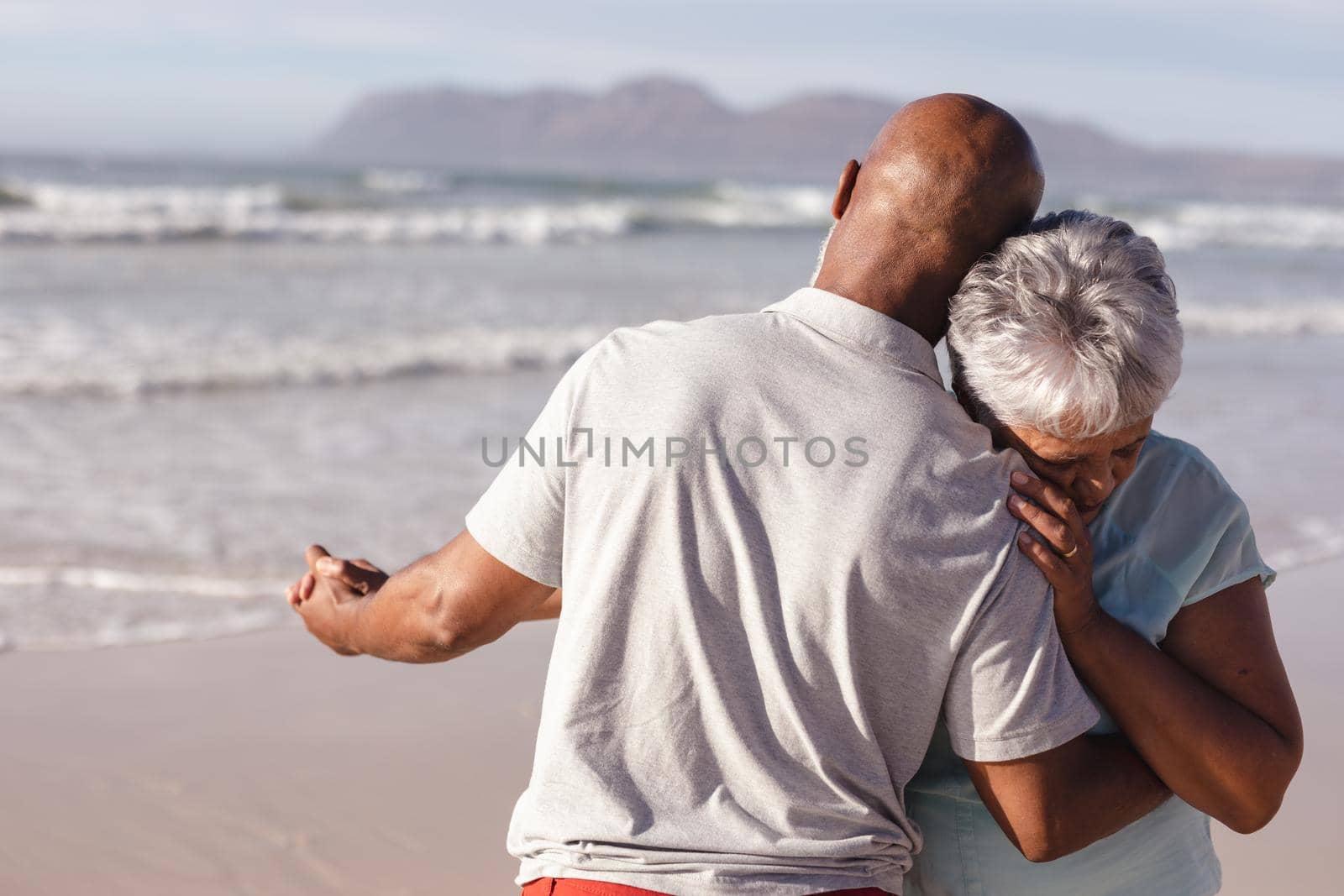 Close up of senior african american couple dancing together on the beach by Wavebreakmedia