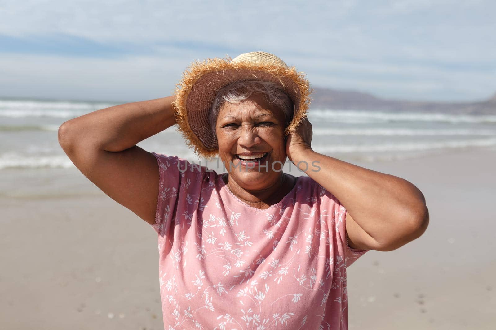 Portrait of senior african american woman smiling on the beach by Wavebreakmedia