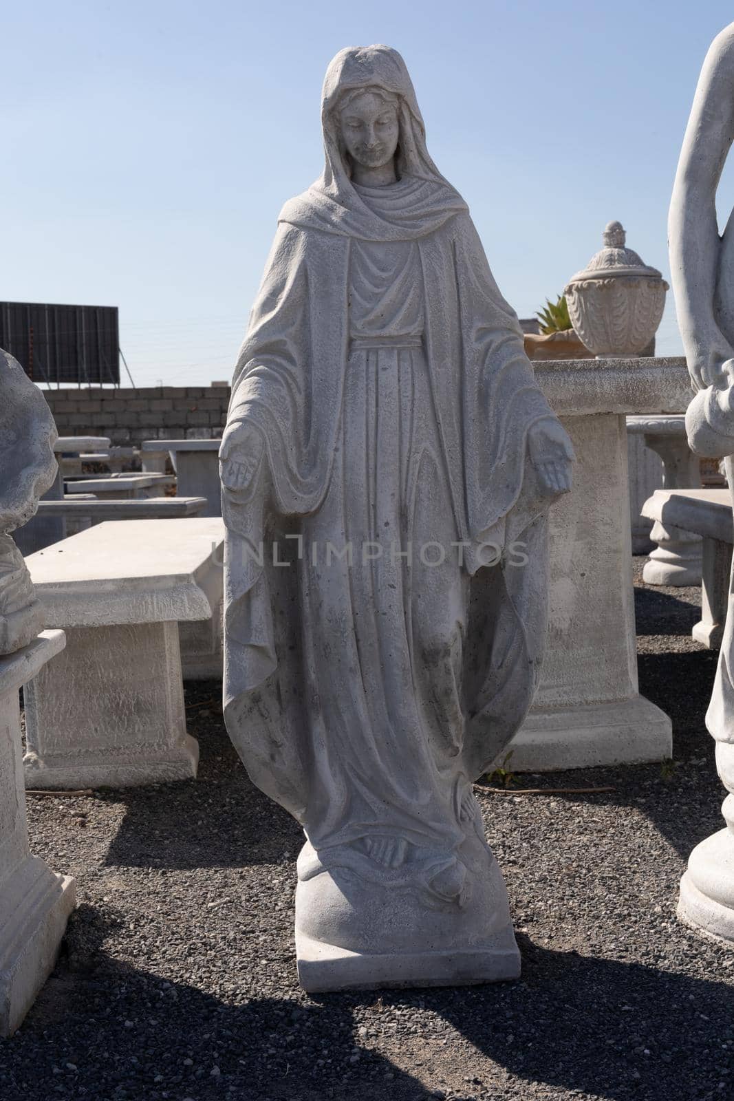 Stone sculpture of virgin mary in reclamation yard. art and classical style romantic figurative stone sculpture.