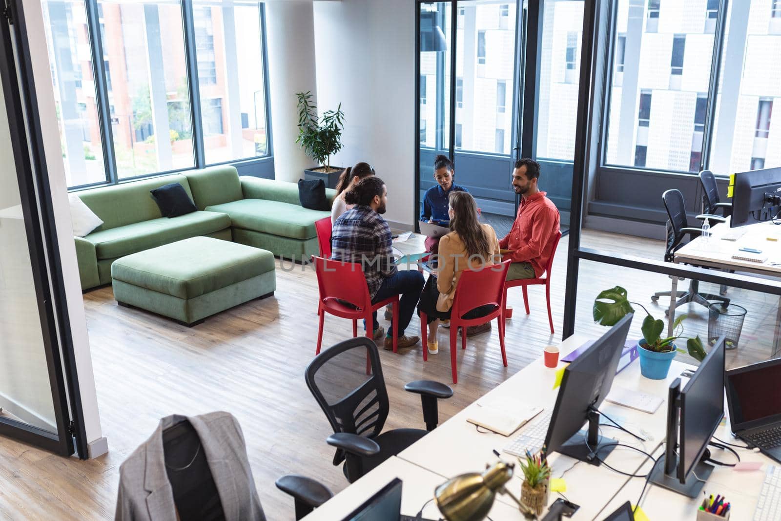 Diverse group of creative colleagues talking at casual meeting by Wavebreakmedia